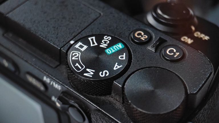 Detailed view of a DSLR camera mode dial showcasing various shooting settings.