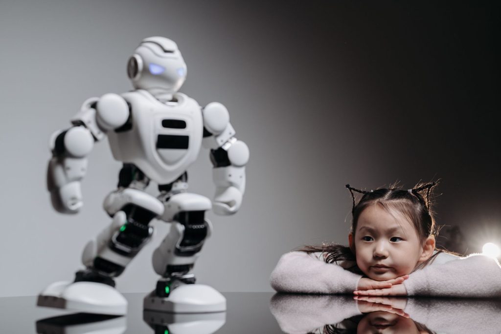 An intrigued child watches a humanoid robotic toy indoors, symbolizing playful tech curiosity.